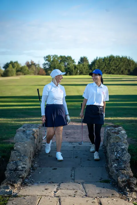 Two golfers walking off a green at Bird Hills on a sunny morning