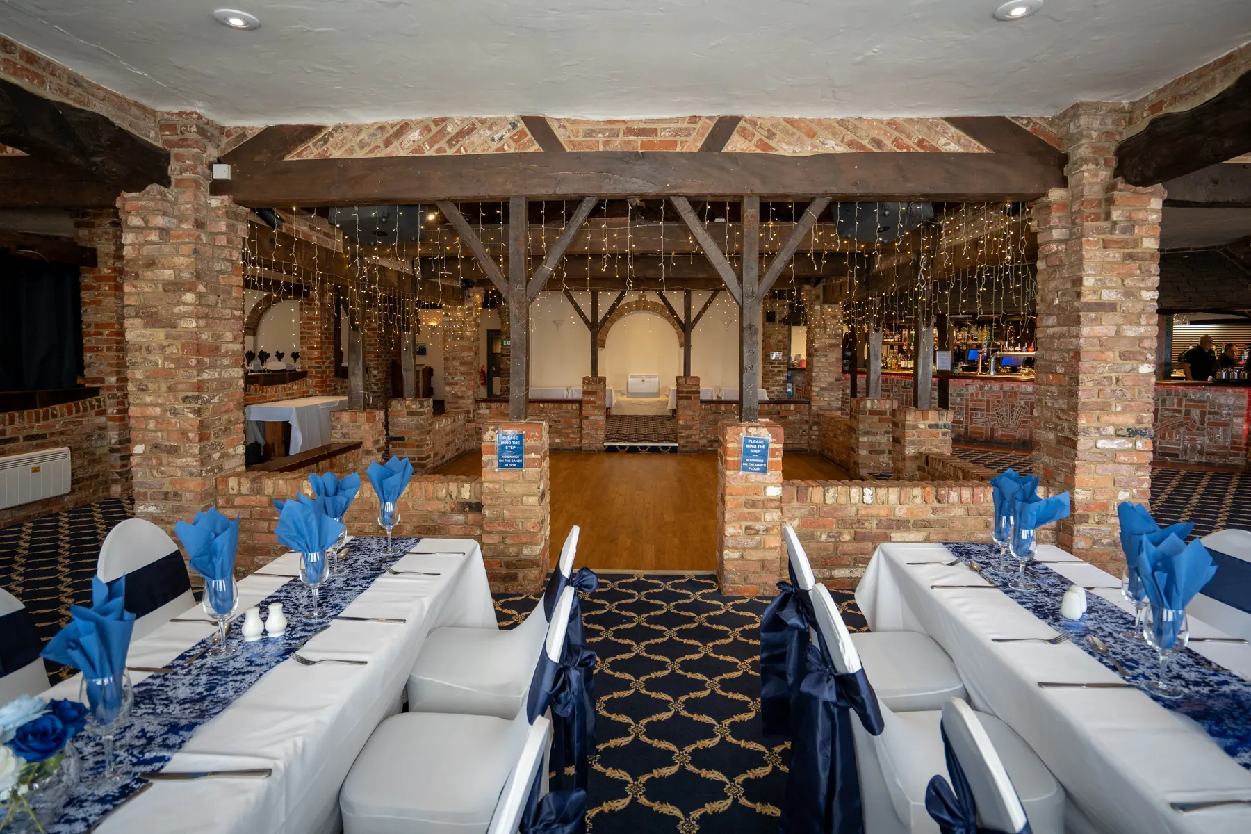 Long tables set with navy sashes in the Elizabethan Restaurant
