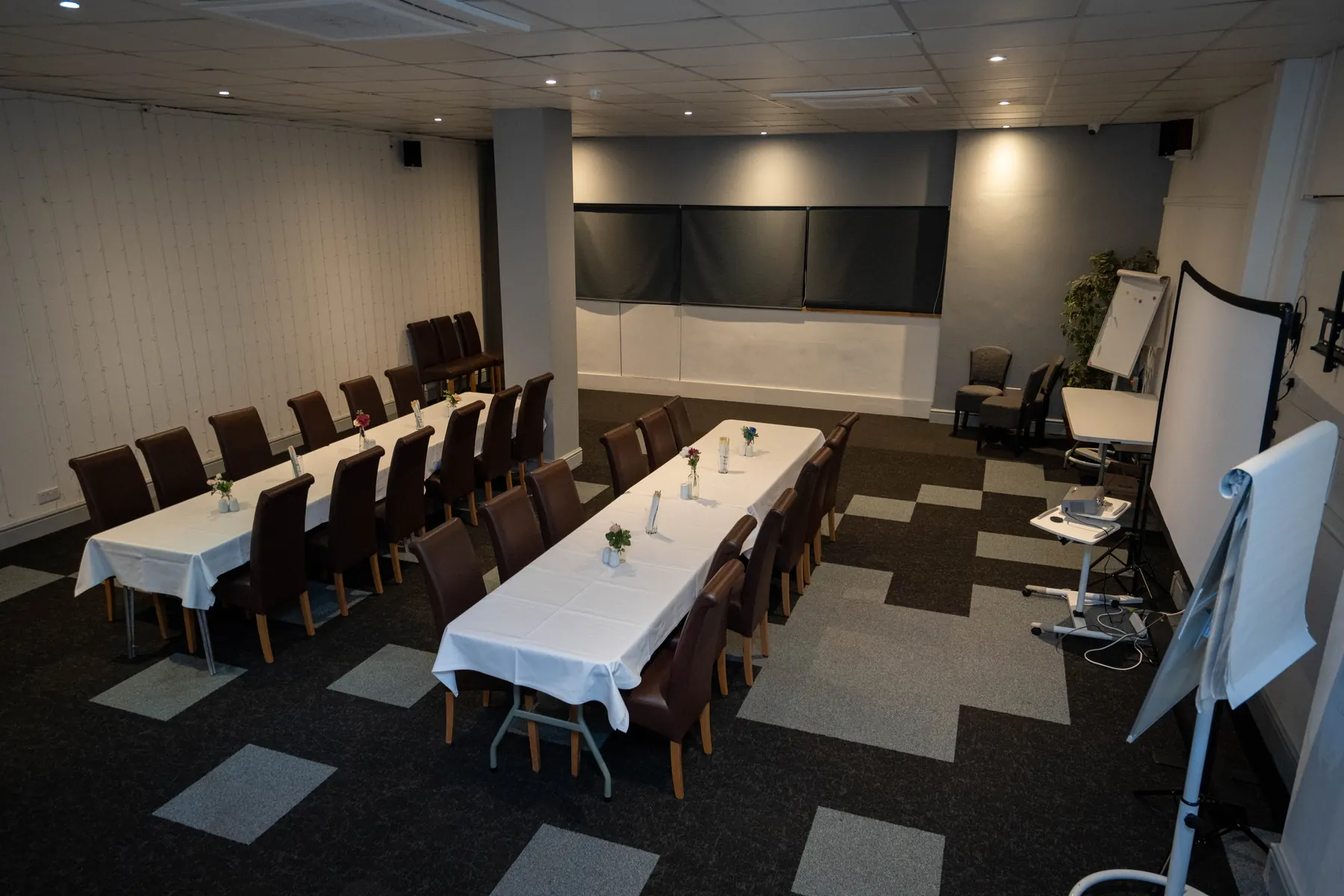 The Hills Bar set with long tables and a projector screen