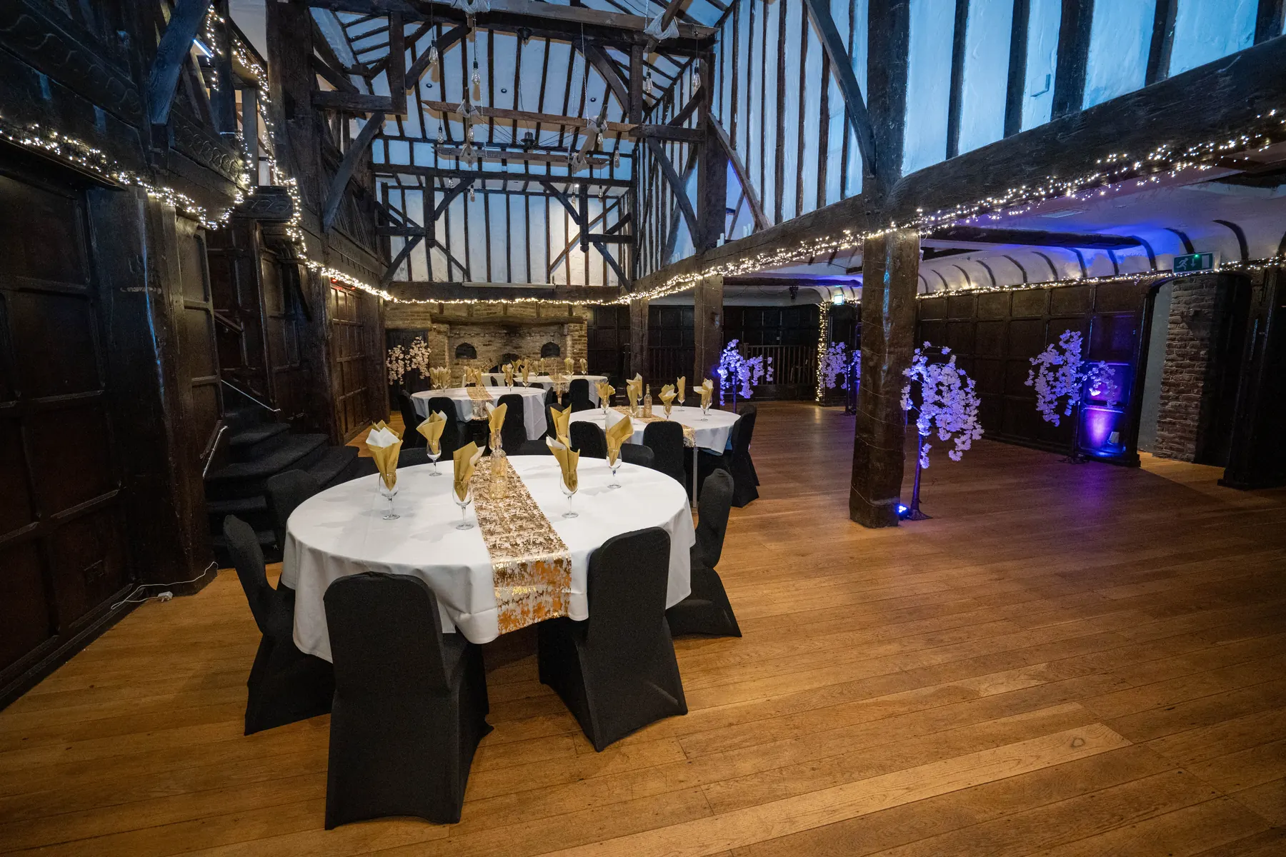 Round tables set in the Baronial Hall beneath the gallery